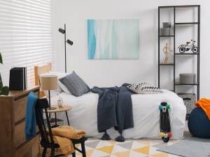 Teen bedroom with modern furniture and wall art.